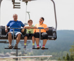 Familj åker sittlift upp för berget i Orsa Grönklitt - spännande upplevelse.