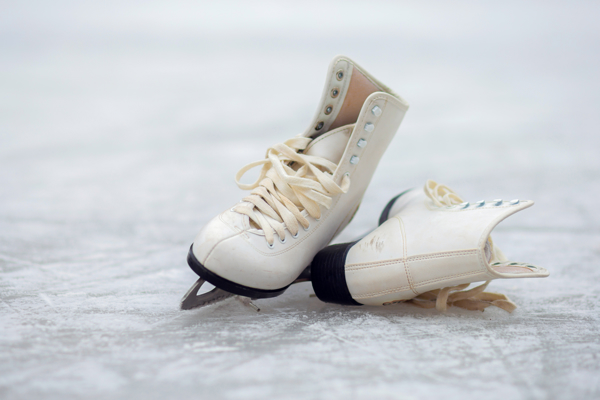 51273023 White Figure Skates Lie On An Open Ice Rink