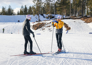 Skidlärare instruerar en längdåkare i Orsa Grönklitt under Längdlektion