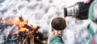42060141 Pouring Hot Drink Out Of Thermos At A Campsite Person